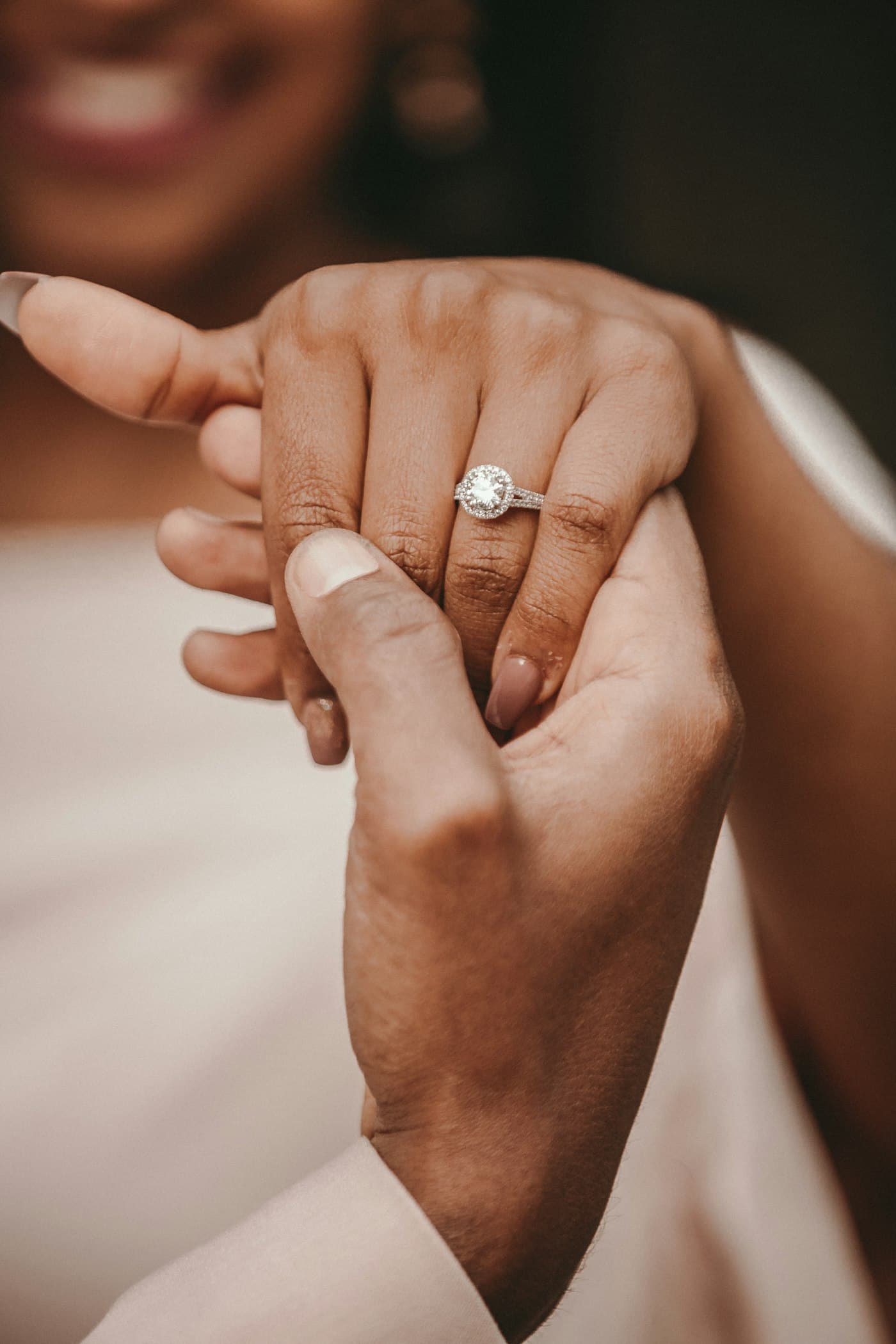 An engagement ring being tried on